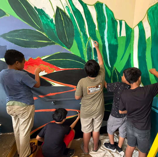 5th grade students at Ben Parker Elementary school painting a mural