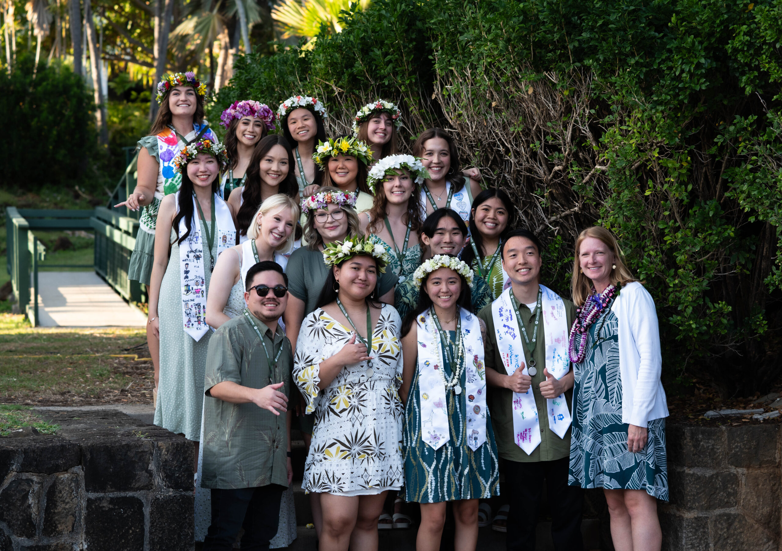 Group photo wearing green attire and white stoles