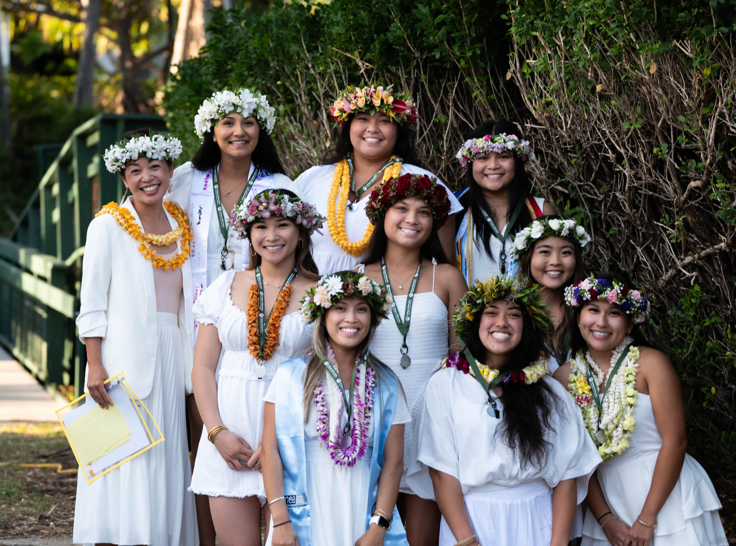 group photo wearing all white, haku and lei