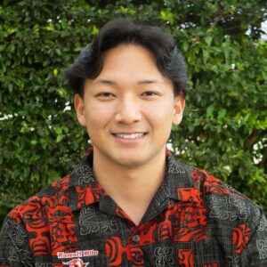 Male of mixed Asian race wearing a red and black aloha shirt