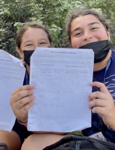 Students holding up a paper
