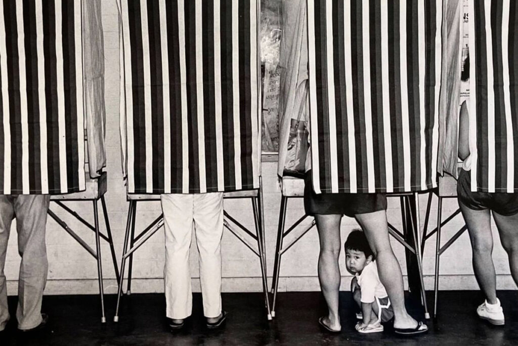 back view of voting booths with legs