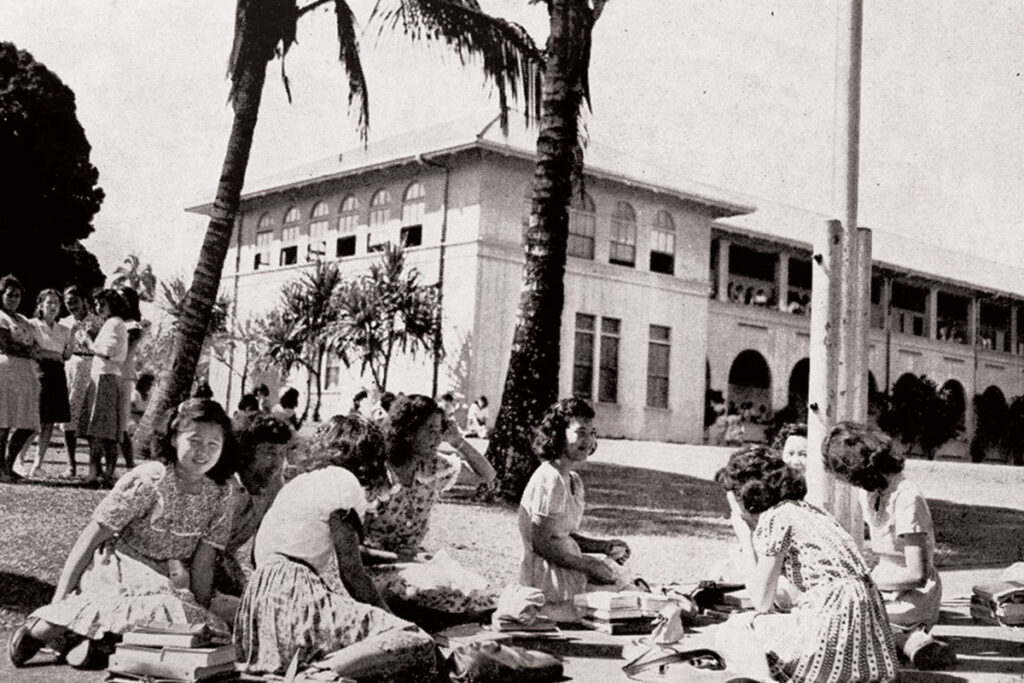 Hilo High School campus females sitting on grass, 1948